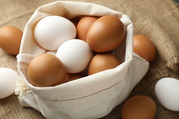 Different raw chicken eggs on table, closeup