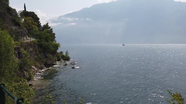 Aerial shot of Lake Garda springtime with ferry cruising near Limone shores