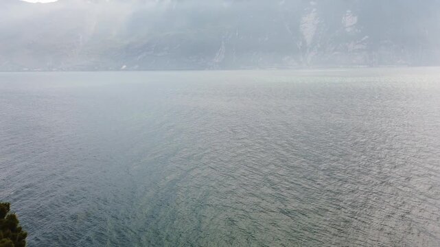 Aerial shot of Lake Garda springtime with ferry cruising near Limone shores