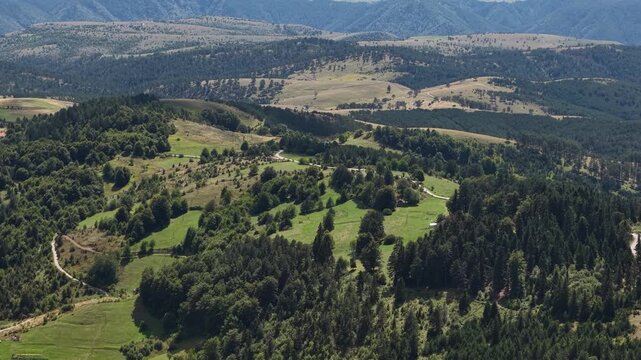 Aerial View of Beautiful Mountain Landscape, Green Forest, Meadows and Misty Horizon on Sunny Summer Day