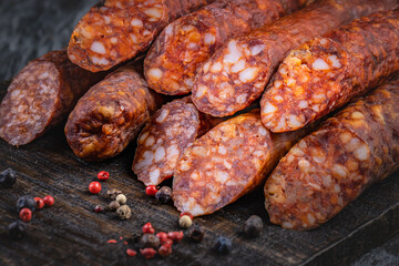 Detail of traditional Spanish sausage Fuet Salami on wooden background