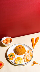 Egg fried rice served hot with vegetables and savory seasoning. Simple and delicious Indonesian dish, perfect for everyday meals or food photography