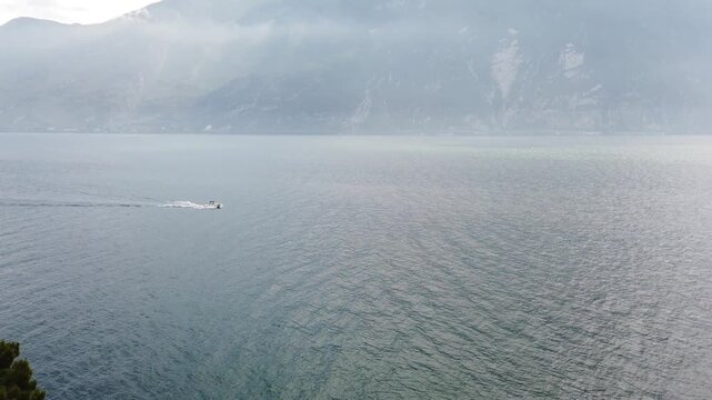 Aerial shot of Lake Garda springtime with ferry cruising near Limone shores