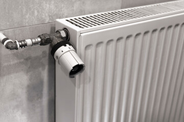 Temperature control knob on room battery. Metal radiator with individual control. heating system,...