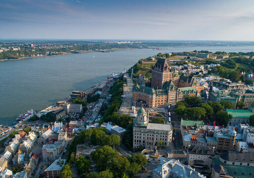 Aerial view of the majestic Ch&acirc;teau Frontenac stands proudly amidst a tapestry of green trees and historic buildings along the St. Lawrence River, Qu&eacute;bec City, Quebec, Canada.