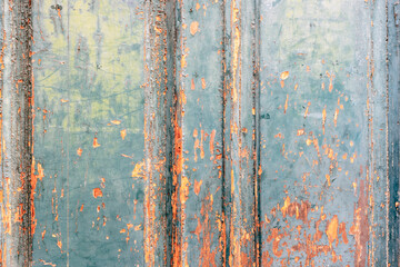 Old painted wooden surface with peeling turquoise and orange texture. Background