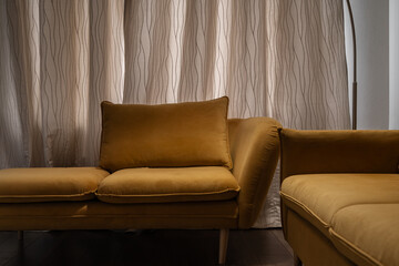 design of stylish living room with stylish yellow sofas, floor lamp next to sofa. soft muted light from lamp creates atmosphere of comfort and relaxation. sofa is close. Illuminated by lamp.