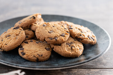 Baked chocolate chip cookies on wooden table