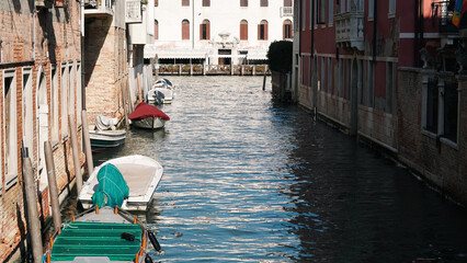 Traditional gondola near old houses in bright daylight in Venice © Наталья Добровольска