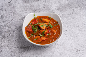 Chicken Tikka Masala Curry – Classic Indian curry with tender tandoori chicken pieces in a rich tomato and spice-infused masala sauce, garnished with fresh coriander, served in a white bowl