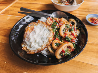 Savor the taste of a delicious stirfried squid dish, complemented perfectly by egg and rice