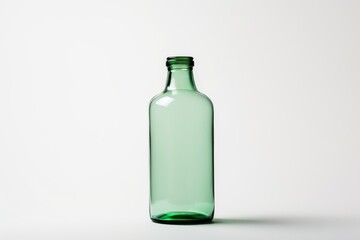 Studio shot of an empty green glass bottle on a white background, representing concepts like recycling, reuse, and the potential for new beginnings