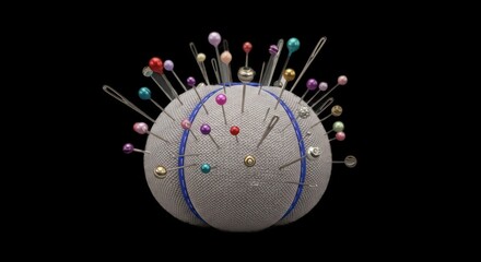 Isolated pincushion with assorted colorful pins against a dark background.