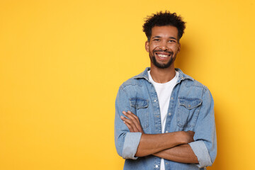 Portrait of happy man on orange background, space for text