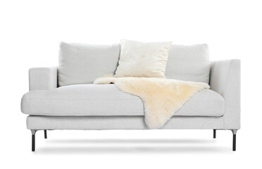 Soft sofa with pillows and faux fur isolated on white