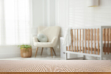 Empty wooden table in baby room. Space for design