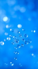 A mesmerizing abstract wallpaper featuring suspended water droplets glistening against a vibrant, blurry blue bokeh background