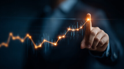 A person pointing at a glowing line graph with an upward trend on a dark blue background