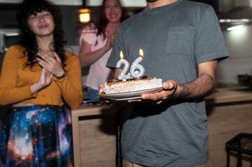 Friends clapping and smiling in warm Christmas 2026 New Year home party 