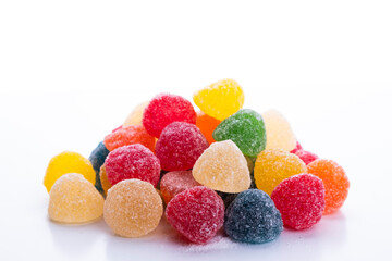 colored jelly beans in different flavors on a white background