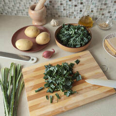 Peeled kale on wooden board at home. Healthy eating, farm produce.