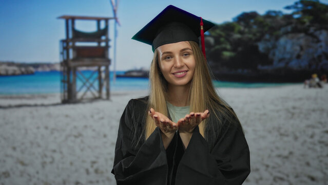 Young woman in graduation uniform smiles on a beach near the sea with palms open against a blue sky and lifeguard tower in the backdrop. - Powered by Adobe