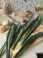 Kale leaves on wooden board at home. Healthy eating, farm produce.