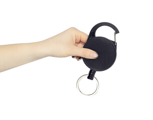Retractor with carabiner and cable in hand, outstretched hand with Keychain with Cable, isolated on...
