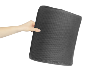 Chair back cushion for posture support in hand, outstretched arm with chair back cushion for posture support, isolated from background	