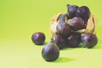 Close up, fresh figs on a green background.