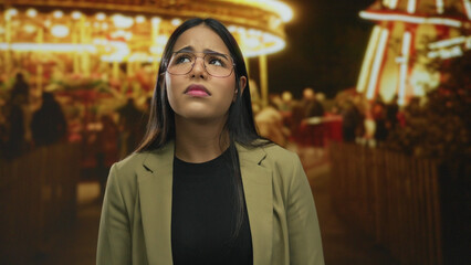 Woman face sad fair night outdoor young latin hispanic glasses detail conveys deep solitude.