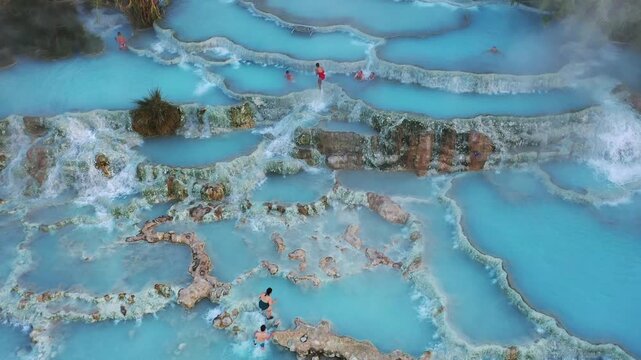 Toscana, Italy - 19 October 2025: Aerial view of the cascading thermal pools of Saturnia, where turquoise waters meet the textured earth in a stunning vista.