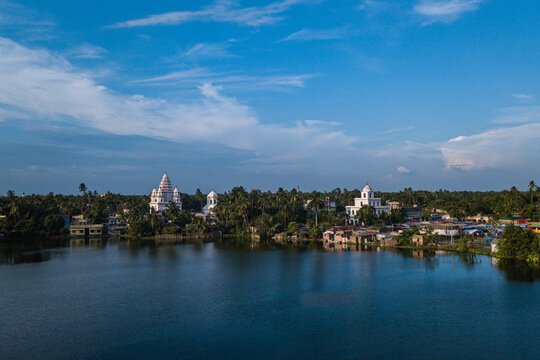 Scenic landscape of a Hindu temple complex on the bank of a large lake in rural Bangladesh Puthia Rajshahi
