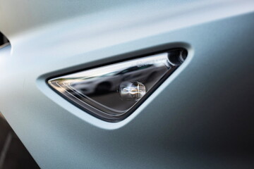 New car's triangle shaped fog or mist light unit. Close up shot, no people