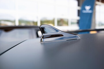 New car's shark fin shaped aerial or antenna. Close up shot, shallow depth of field, no people