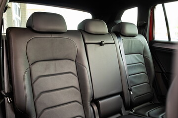 New car empty leather back seats. Close up, wide angle view, no people
