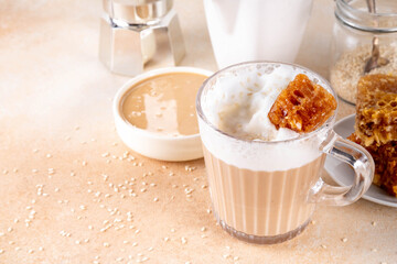 Tasty sweet and salted tahini honeycomb latte. Hot coffee drink with whipped non-dairy creamer, tahini sesame paste, honey and honeycomb garnish