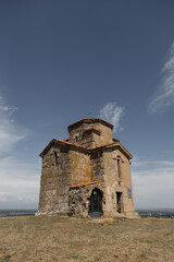 An ancient stone church beautifully situated on a serene hilltop