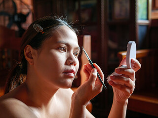 Beauty & Skincare, A woman who draws makeup, eyebrows, Asian woman makes a make-up in front of mirror, draws eyebrows with a pencil
