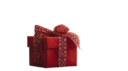 A single, large red Christmas gift in the foreground, with a fully decorated, slightly out-of-focus Christmas tree behind it. Professional product shot, clean setting.