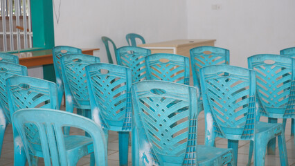 ​Empty Blue Plastic Chairs in a Simple Classroom or Meeting Room