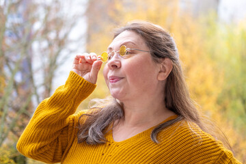 Mature woman 50 years old wearing glasses, poor vision, myopia problem, optical exam, diopter...
