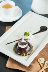 A gourmet dessert with a side of tea, showcasing the artistry and deliciousness