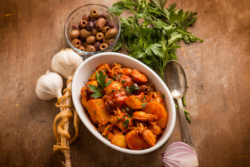 squid with tomato sauce olives and potatoes