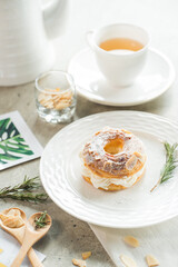 Delicious dessert with a cup of tea, ready for afternoon delight. A tempting pastry is served alongside a cup of tea on a table