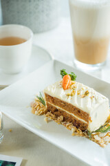 Delectable carrot cake, beautifully presented alongside a beverage, a perfect treat