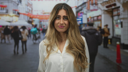 Fototapeta premium Woman clasping chest in street; nervous anticipation.