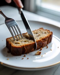 Slicing Freshly Baked Banana Bread or Tea Cake on a White Plate with Gold Rim, dry cake on a plate