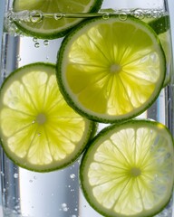 Refreshing Close-Up of Translucent Lime Slices in Carbonated Water with Bubbles, lime slices background