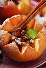 Closeup of baked apple with vanilla cheese, walnuts and raisins for Christmas